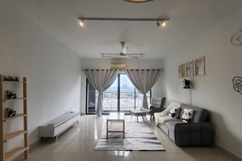 a living room with a couch and a table at Netflix High Speed Internet 9pax Cinema Theme house Setiawalk with pool in Puchong