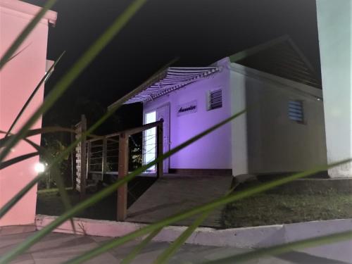 a purple door of a house with a fence at Domaine de Sainval in Sainte-Rose