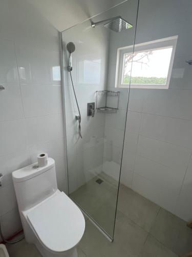 a white bathroom with a shower and a toilet at You&Me Resort in Koh Rong Island
