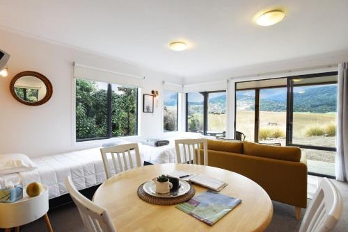 a living room with a table and a couch at Mohua Park - Catlins Eco Accommodation in Owaka