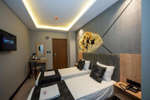 a hotel room with two beds and a tv at Comfort Point in Istanbul