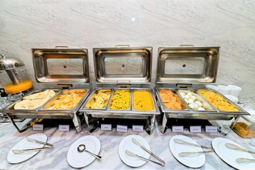 a buffet with many trays of food on a table at The Shahin Residence - Mohakhali in Dhaka