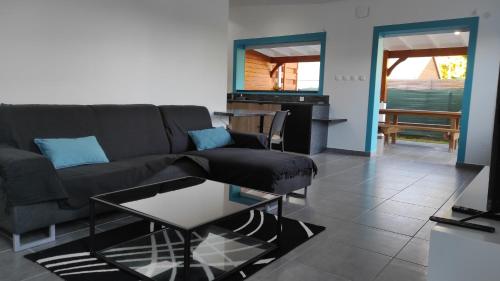 a living room with a couch and a table at Domaine de Sainval in Sainte-Rose