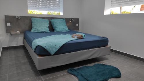 a dog laying on a bed in a bedroom at Domaine de Sainval in Sainte-Rose