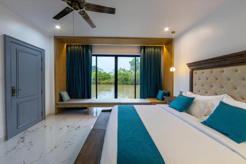 a bedroom with a large bed and a large window at SS Villa & Resort in Trâpeăng