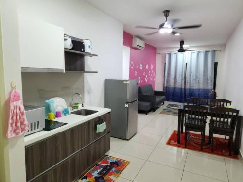 a kitchen and living room with a refrigerator and a table at New Modern Condo with Pool at Bangi in Kampong Tangkas