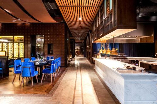 a dining room with blue chairs and a table at Crowne Plaza Vientiane by IHG in Vientiane