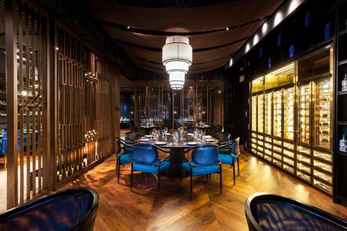 a dining room with a table and blue chairs at Crowne Plaza Vientiane by IHG in Vientiane