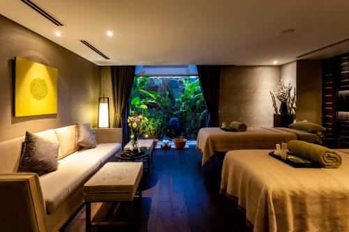 a hotel room with two beds and a couch at Crowne Plaza Vientiane by IHG in Vientiane