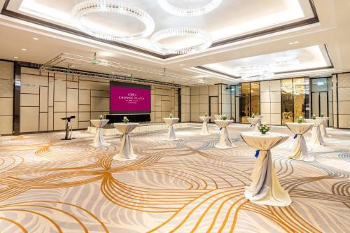 a large room with tables and a projection screen at Crowne Plaza Vientiane by IHG in Vientiane