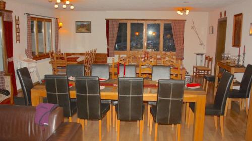 a dining room with a table and chairs at Outstanding chalet for groups, south facing, breathtaking views - all year round in Anzère