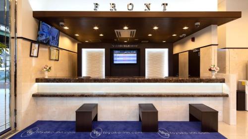 a lobby of a hotel with two stools at Toyoko Inn Kashiwa-eki Higashi-guchi in Kashiwa