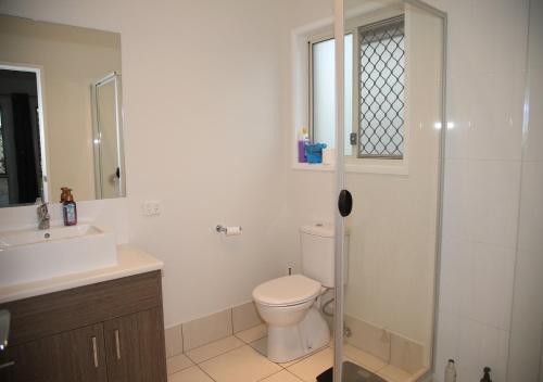 a bathroom with a toilet and a sink and a shower at The Summer Lakeside Room in North Lakes