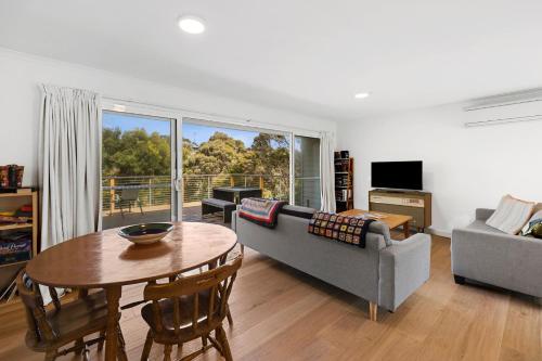 a living room with a couch and a table at Myrtle Cottage in Aireys Inlet