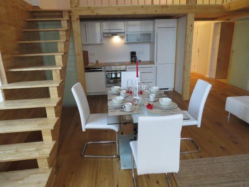 a dining room with a table and white chairs at Apartments Alserstraße in Vienna