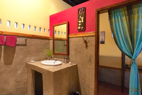 a bathroom with a sink and a mirror at Mandala Ou Resort in Nongkhiaw