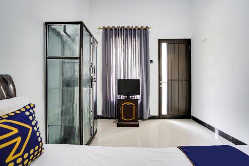 Postel nebo postele na pokoji v ubytování SPOT ON 91745 Rumah Kost Gresik Syariah