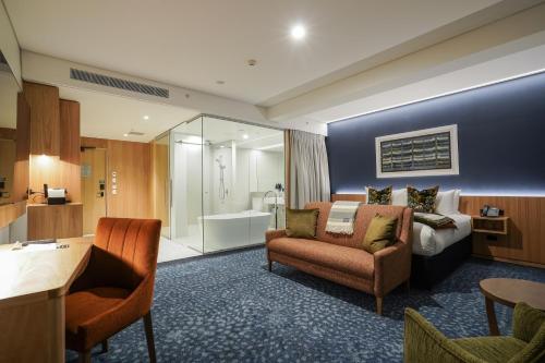 a hotel room with a bed and a bathroom at The Langlands Hotel in Invercargill