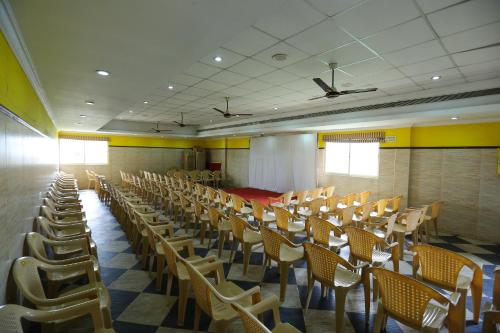 an empty room with chairs and tables and ceilings at Season 4 Residences - Teynampet Near Apollo Hospital ,Balaji Dental, US Consulate in Chennai