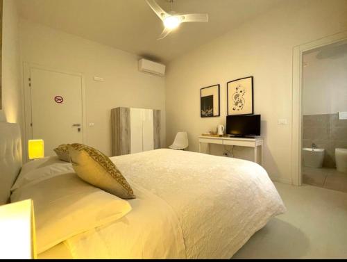 a bedroom with a large bed and a bathroom at B&B Campesio al2 in Piacenza