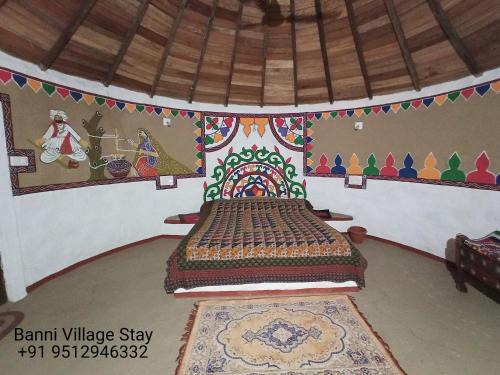 a bedroom with a bed in a room at Banni Village Resort - Rann Of Kutch in Bherandiāla