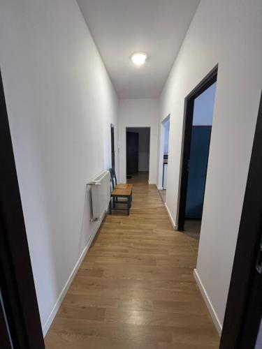 a hallway with white walls and a wooden floor at Przy Poznańskiej Bramie in Inowrocław