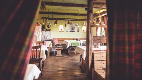 a restaurant with tables and chairs in a room at Penzion a Restaurace U Johana in Zlín