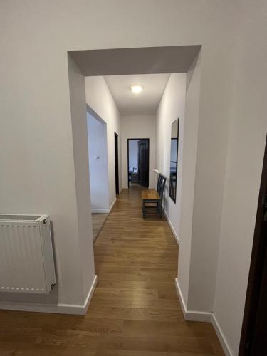 a hallway of a home with white walls and wooden floors at Przy Poznańskiej Bramie in Inowrocław
