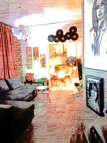a living room with a couch and a table at Casolare Isabella "Il rifugio dei vinili" and Alice's room in Ponsacco
