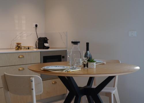 a table with wine bottles and glasses on it in a kitchen at סיני 48 מלון דירות בוטיק in Vered Yeriho