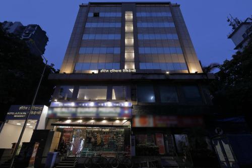 a tall building with a store in front of it at Hotel Ariana Residency in Mumbai