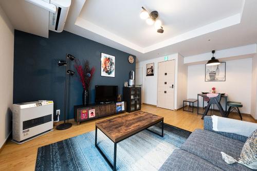 a living room with a couch and a table at AMS TOWER in Sapporo