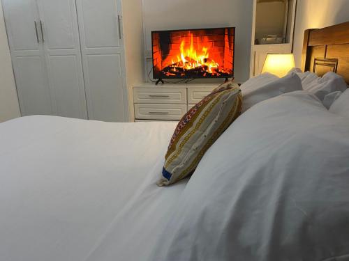 a bedroom with a bed with a fire in the fireplace at El Tessa garden/serviced apartment in Kisumu