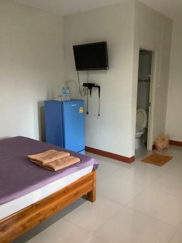 a room with a blue refrigerator and a tv at Sorn Waree Home place in Kanchanaburi City