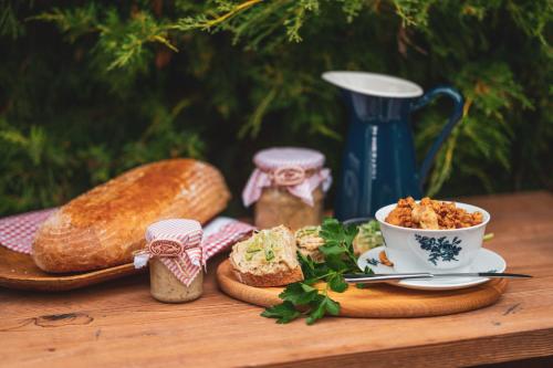 a table with bread and a cup of coffee and a plate of food at Penzion a Restaurace U Johana in Zlín