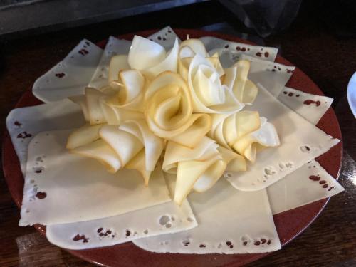 a cake with white roses on a red plate at Hotel U Ševce in Zlín