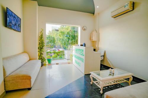 a living room with a couch and a table at Hotel Mansarovar Palace in Jaipur