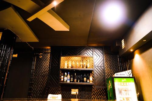 a bar with bottles of alcohol on a shelf at Hotel Mansarovar Palace in Jaipur