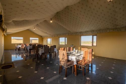 a dining room with a table and chairs at Rajwada Desert Camp in Jaisalmer