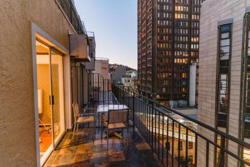 a balcony with a table and chairs on a building at Cape Diamond Boutique Hotel in Cape Town
