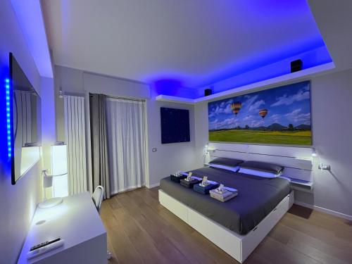 a bedroom with a bed with a large painting on the wall at Relax in Milano - Ventura - Lambrate - Città Studi in Milan