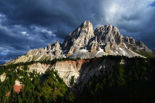 a large mountain with trees in front of it at Canalhof in Antermoia