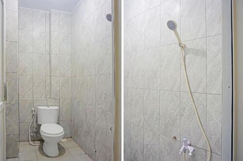 a bathroom with a toilet and a shower at SUPER OYO Capital O 91790 S1 Residence in Tangerang