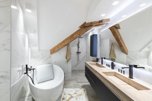a bathroom with a toilet and a sink at Mairnaige, luxueux appartement avec sauna in Gérardmer