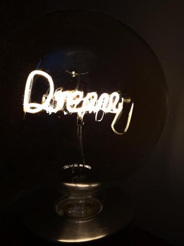 a neon sign that says open on a table at ThePlatres.Nest in Platres