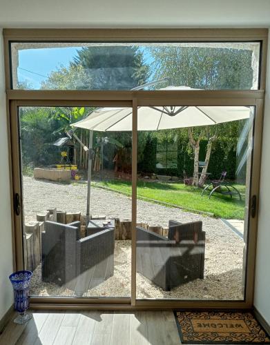 a view of a patio through a sliding glass door at Au Mont & Merveilles in Sartilly