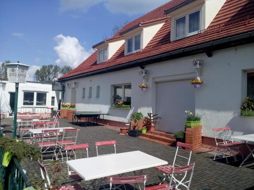 a group of tables and chairs outside of a building at Hotel Landhaus Nassau in Meißen