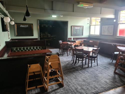 a dining room with tables and chairs and a chalkboard at The Hen House in Cannock