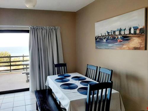 a dining room with a table and a view of the ocean at La Corsica Beach House Breakaway in Margate