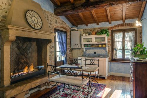 a living room with a fireplace and a clock at Il Borghetto Vacanze nei Mulini in Valeggio sul Mincio